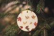 a ceramic ornament hanging from a christmas tree