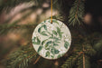 a ceramic ornament hanging from a christmas tree