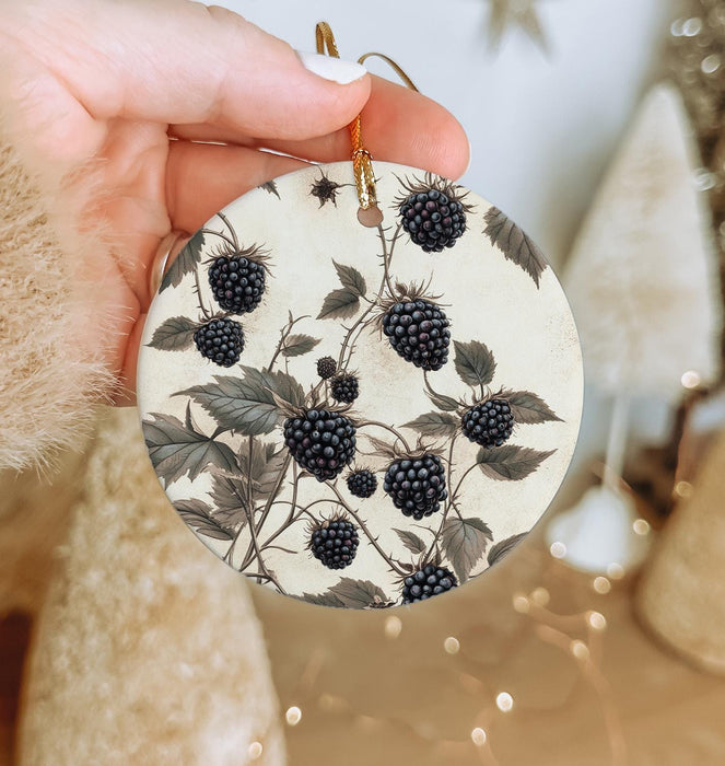 a person holding a round ornament with berries on it