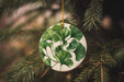 a ceramic ornament hanging from a christmas tree