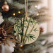 a christmas ornament hanging from a christmas tree