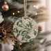 a christmas ornament hanging from a christmas tree