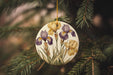 a ceramic ornament hanging from a christmas tree