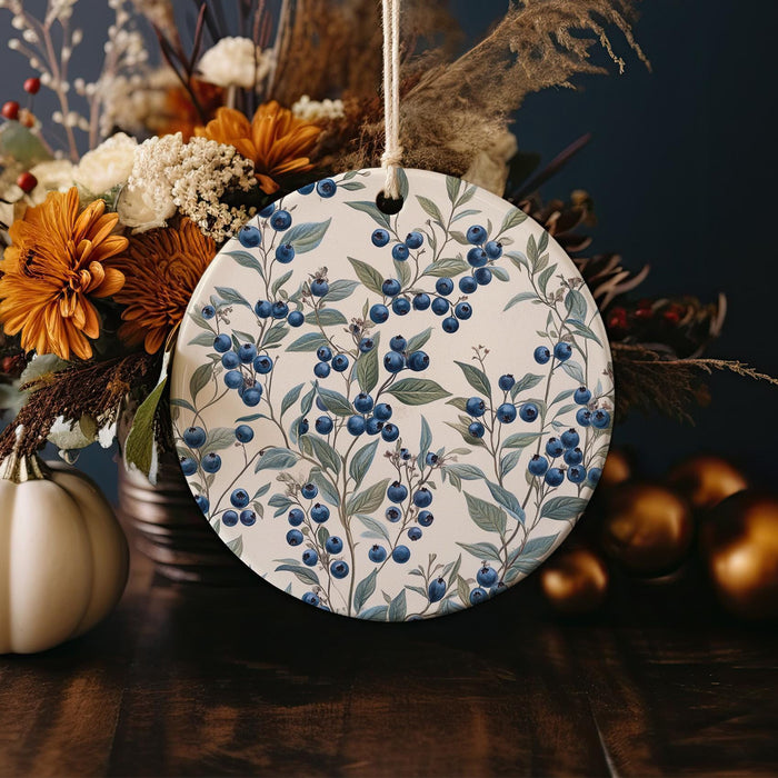 a ceramic ornament with blue berries on it