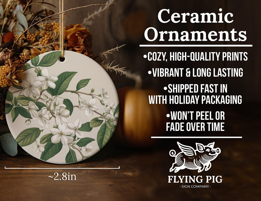 a ceramic ornament with white flowers and green leaves