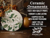 a ceramic ornament with white flowers and green leaves