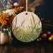 a ceramic ornament with a picture of a cornfield