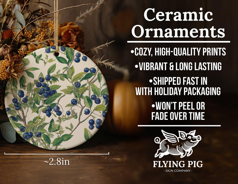 a ceramic ornament with blue berries on it