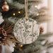 a christmas ornament hanging from a christmas tree