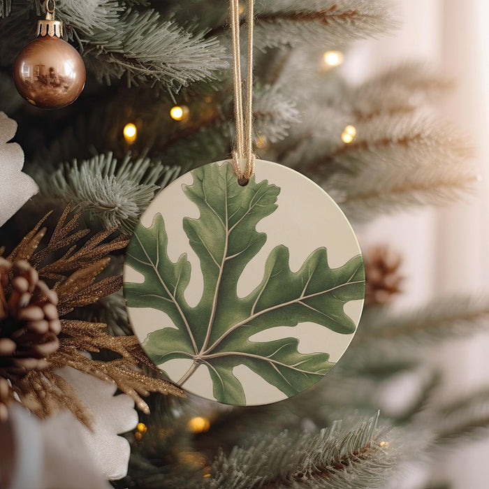 a ceramic ornament hanging from a christmas tree