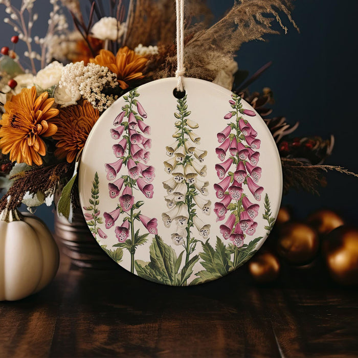a ceramic ornament decorated with flowers and leaves
