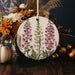 a ceramic ornament decorated with flowers and leaves