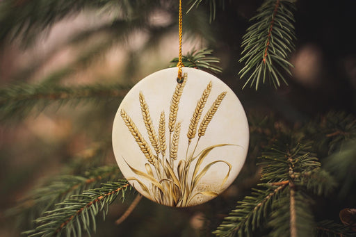a ceramic ornament hanging from a pine tree