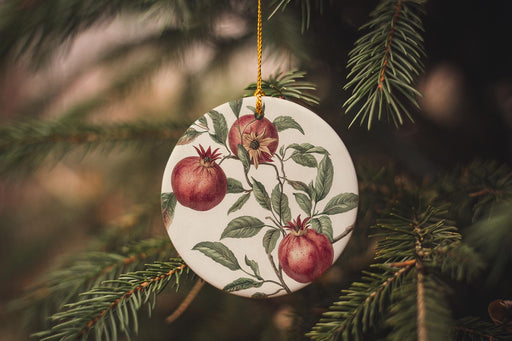 a ceramic ornament hanging from a christmas tree