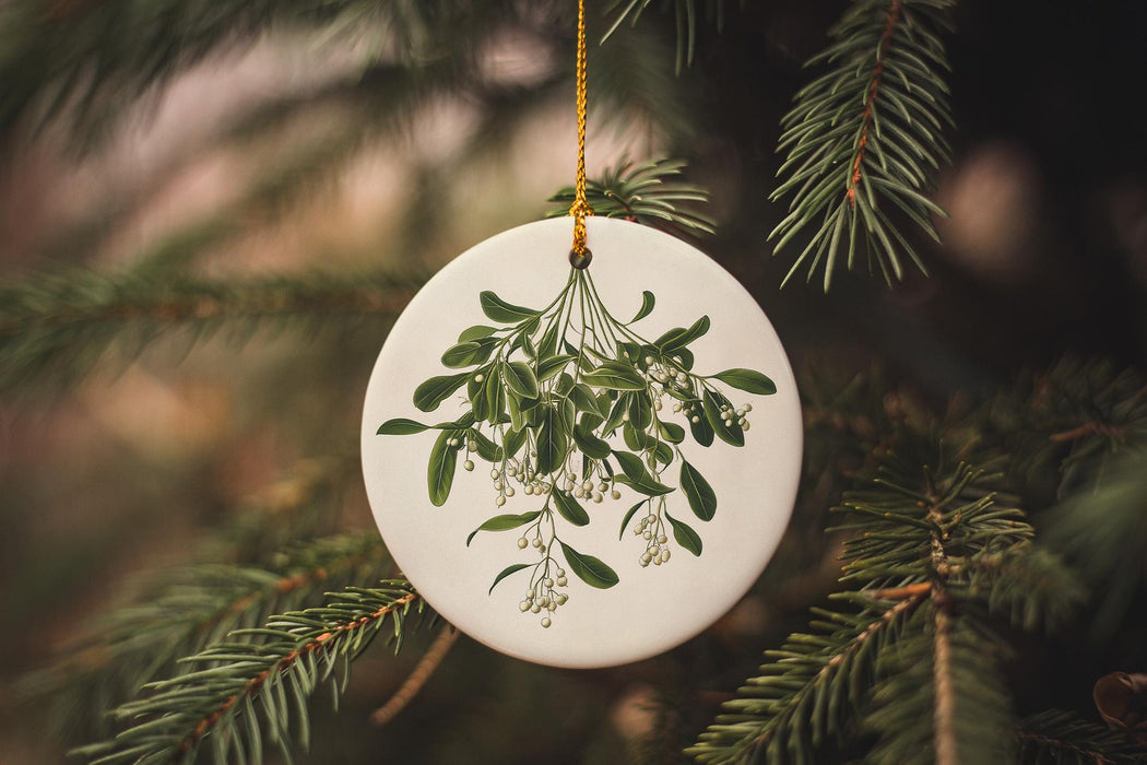 a white ornament hanging from a christmas tree