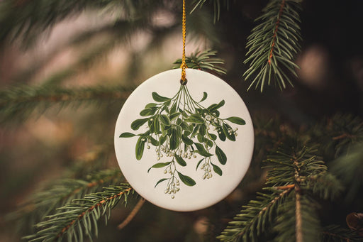 a white ornament hanging from a christmas tree