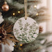 a ceramic ornament hanging from a christmas tree