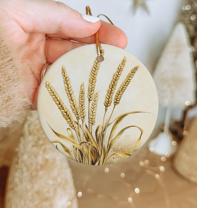 a person holding a round ornament with a plant on it