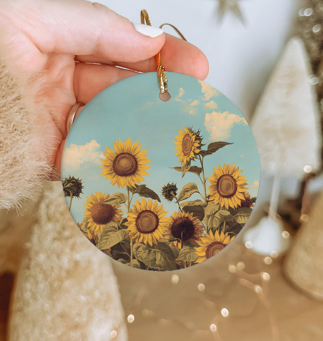 a person holding a sunflower ornament in their hand