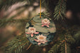 a christmas ornament hanging from a pine tree
