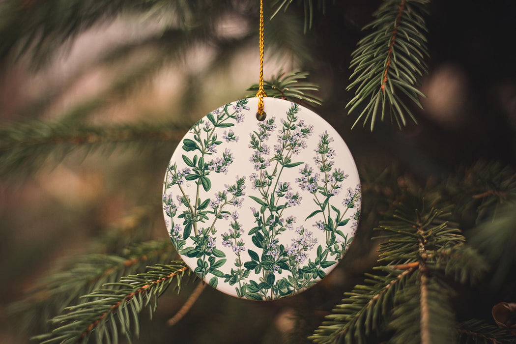 a ceramic ornament hanging from a christmas tree