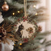 a cat and dog ornament hanging from a christmas tree