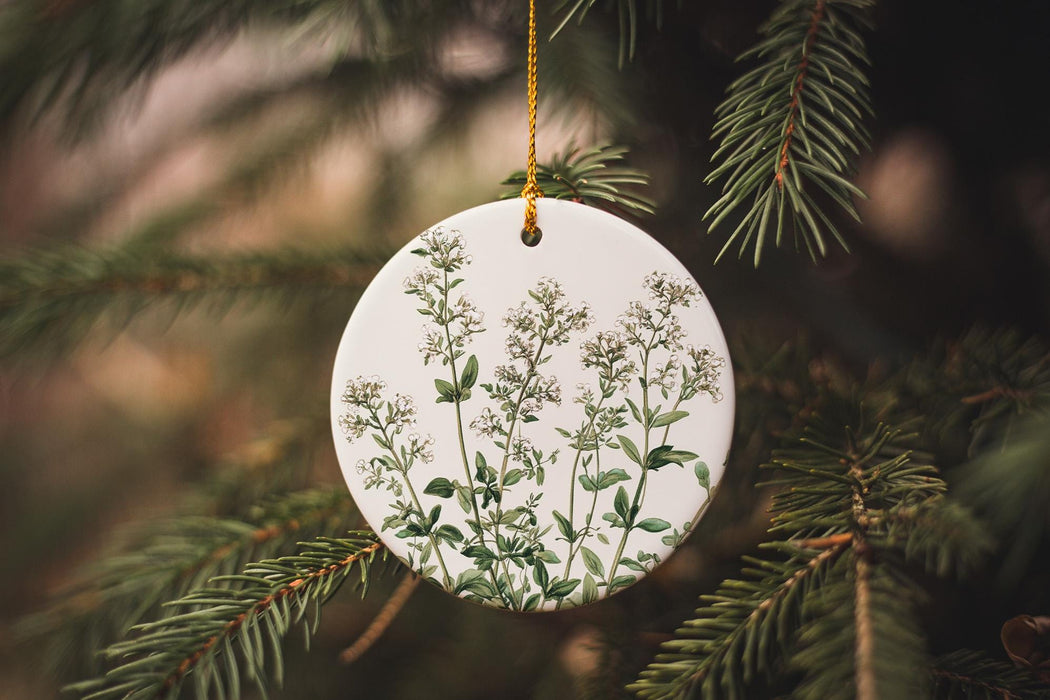 a ceramic ornament hanging from a pine tree
