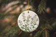 a ceramic ornament hanging from a pine tree