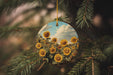 a sunflower ornament hanging from a pine tree