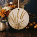 a vase filled with flowers next to a white pumpkin