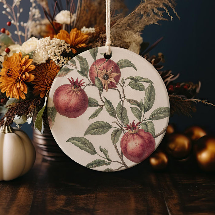 a plate with a painting of apples and flowers on it