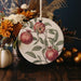 a plate with a painting of apples and flowers on it