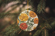 a ceramic ornament hanging from a pine tree