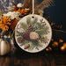 a christmas ornament with pine cones and flowers