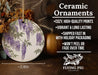 a ceramic vase with purple flowers on it