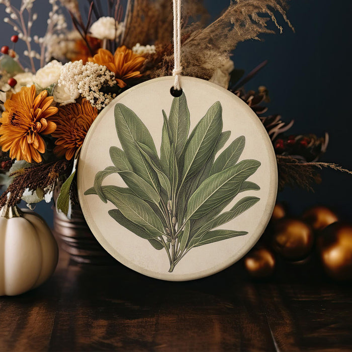 a picture of a green leaf on a white ornament