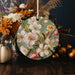 a ceramic ornament decorated with flowers and leaves