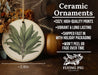 a ceramic ornament with a green leaf on it
