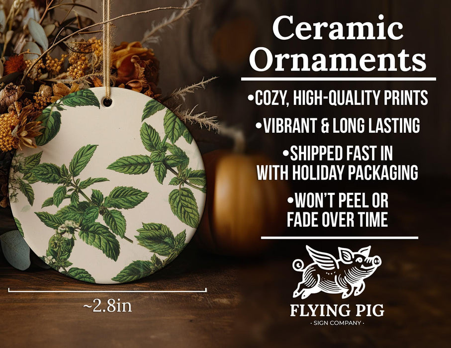a ceramic ornament with green leaves on it