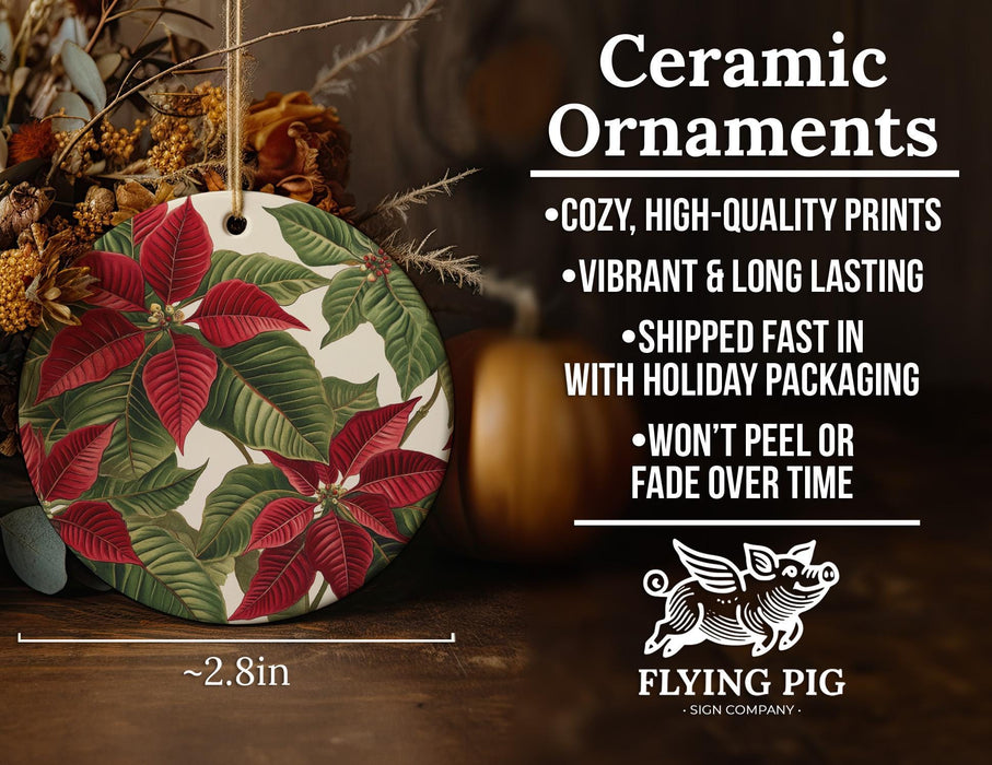 a ceramic ornament with a red flower on it