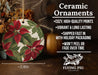 a ceramic ornament with a red flower on it