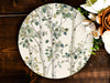 a white plate with a tree design on it