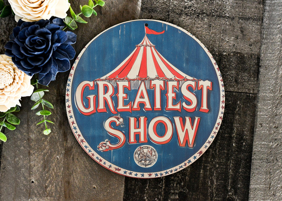 a sign that says greatest show next to flowers