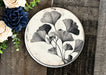a black and white plate with flowers on it