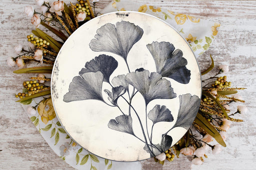 a plate with flowers painted on it sitting on a table