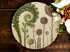 a painting of flowers and plants on a wooden surface