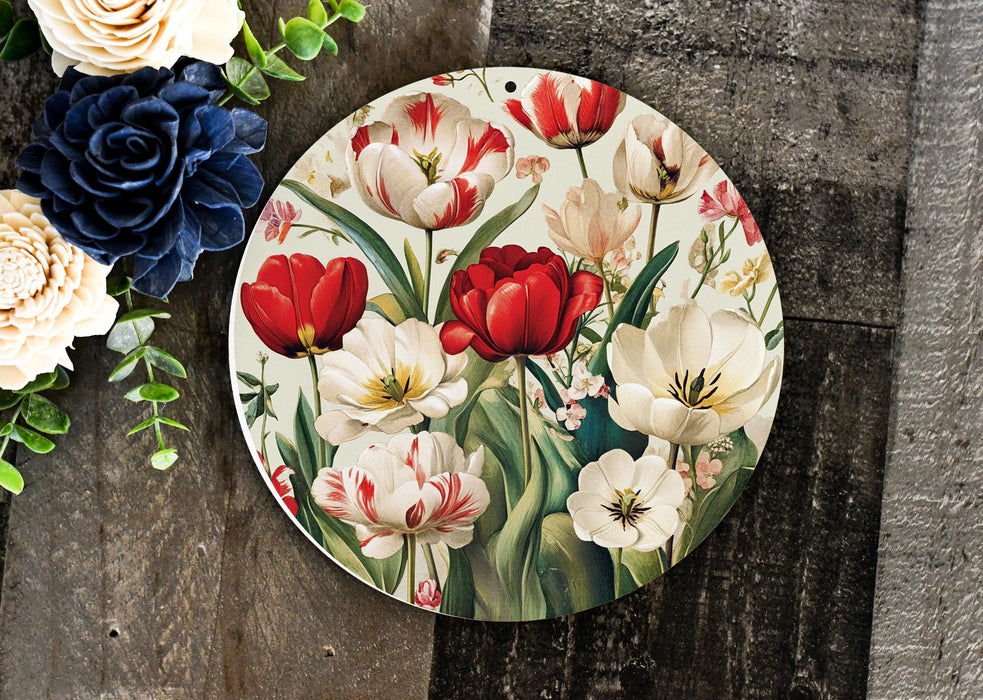 a plate with flowers painted on it next to a bouquet of flowers