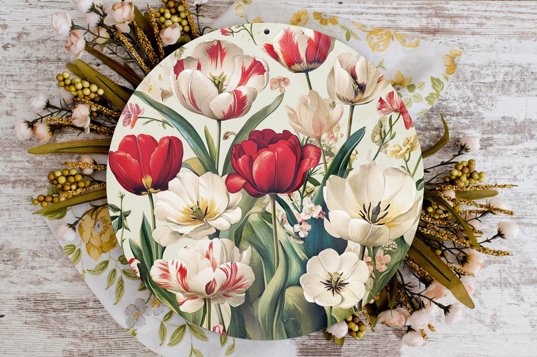 a plate with a painting of red and white flowers on it