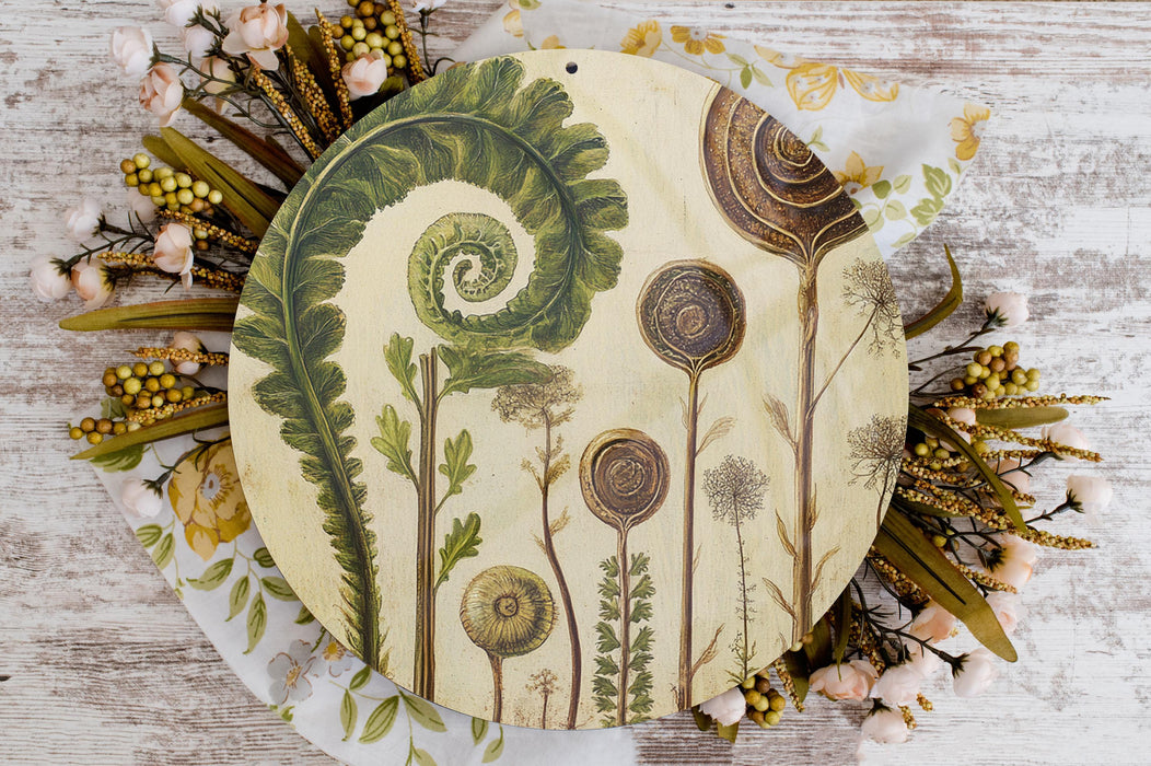 a plate with a painting of flowers and plants on it