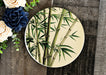a plate with a picture of a bamboo plant on it